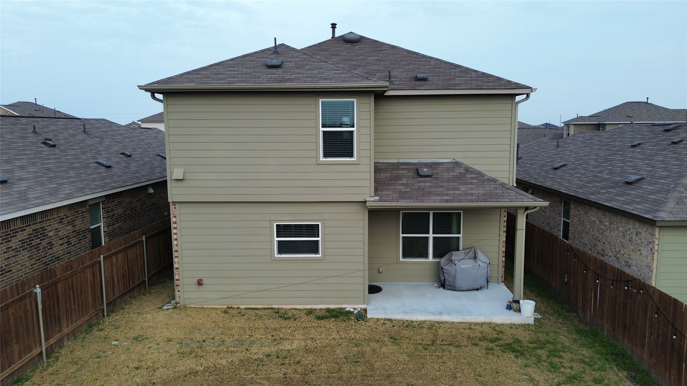 138 Milliner Loop Hutto, TX 78634 - Photo 33 of 36 Back of property with a patio, a shingled roof, and a fenced backyard