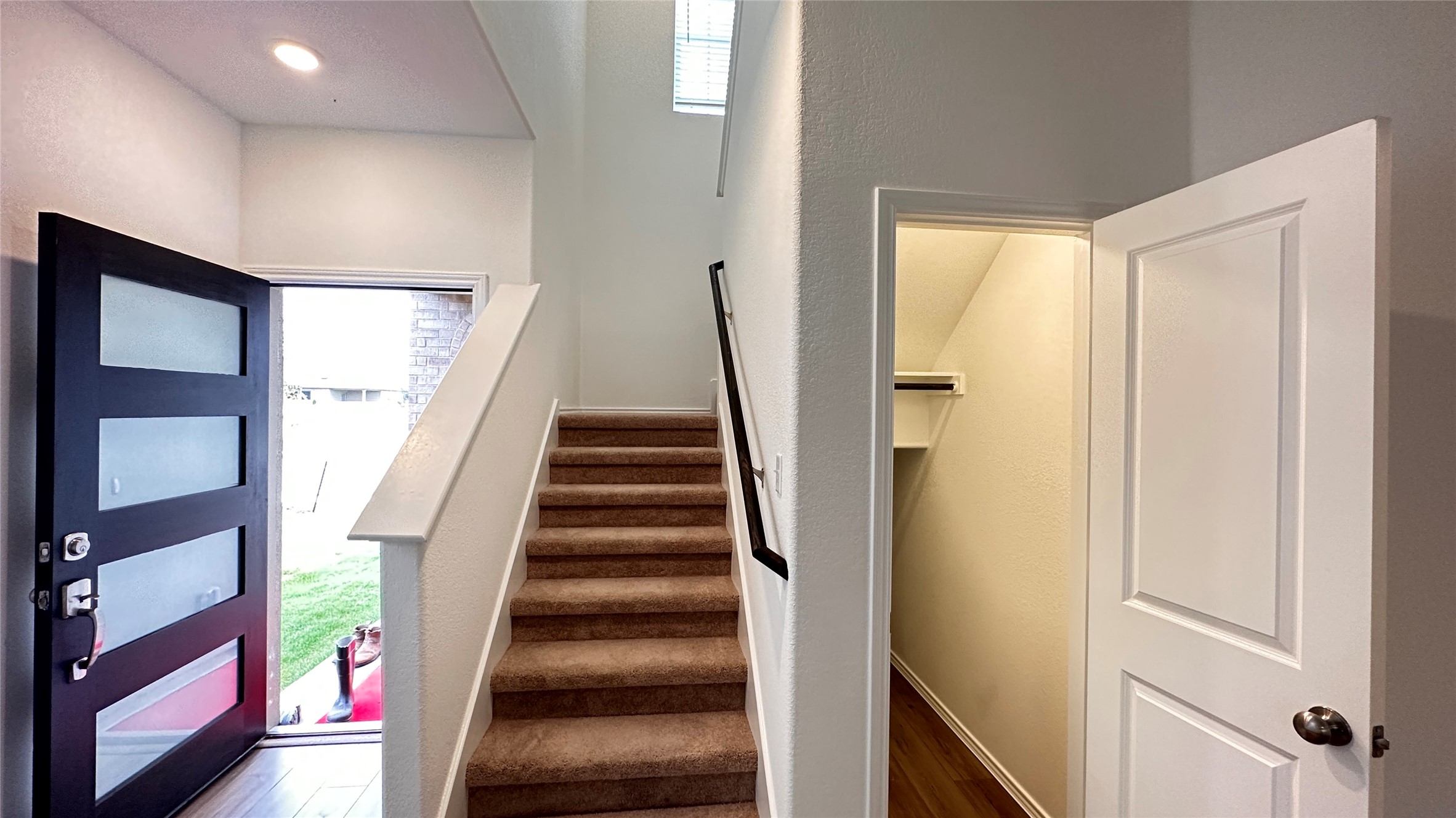 138 Milliner Loop Hutto, TX 78634 - Photo 5 of 36 Staircase with plenty of natural light and wood finished floors