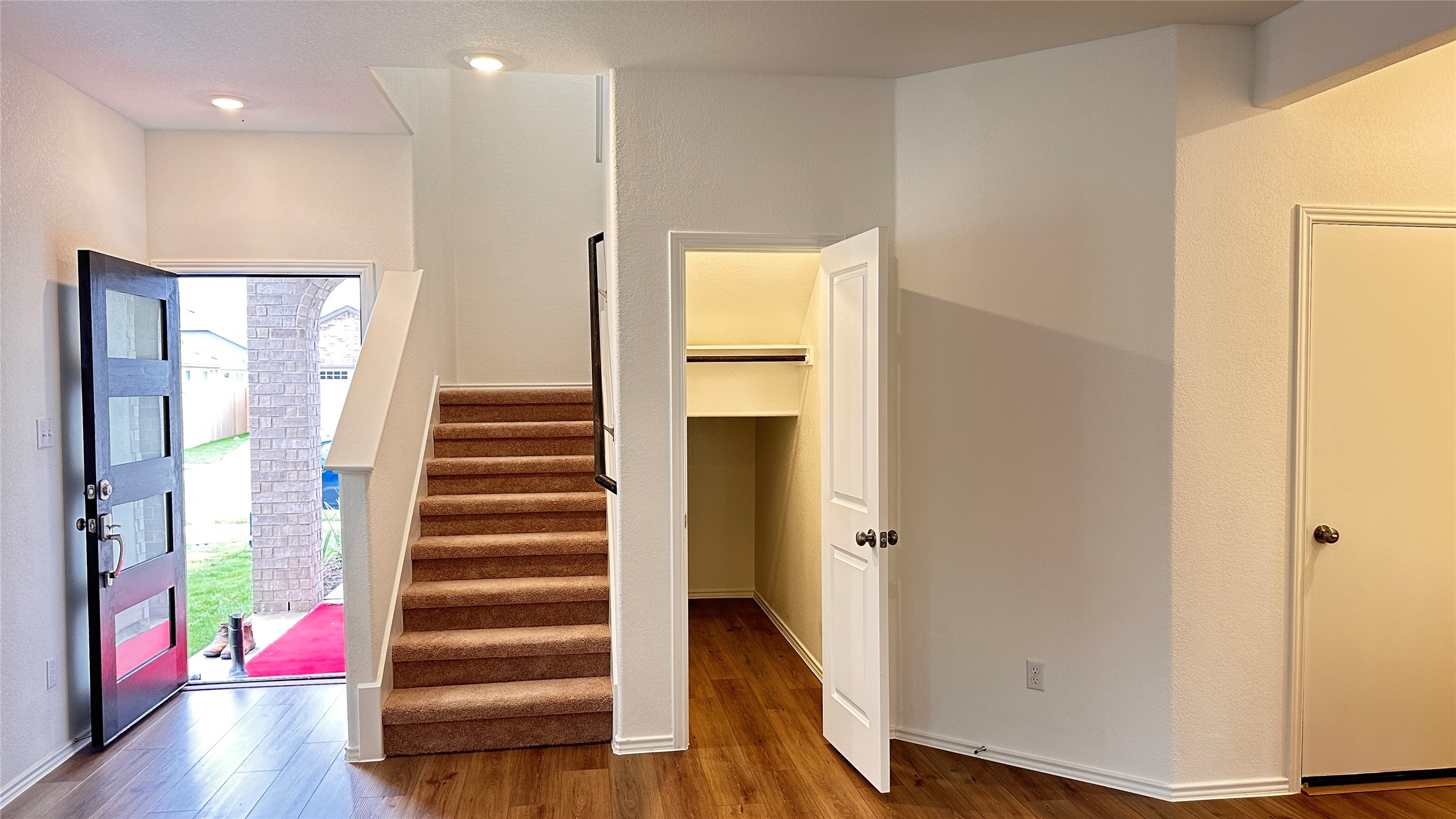 138 Milliner Loop Hutto, TX 78634 - Photo 6 of 36 Foyer entrance with stairs and dark wood-type flooring