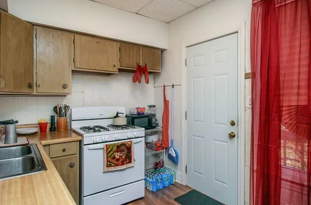 a kitchen with stainless steel appliances granite countertop a stove and a refrigerator