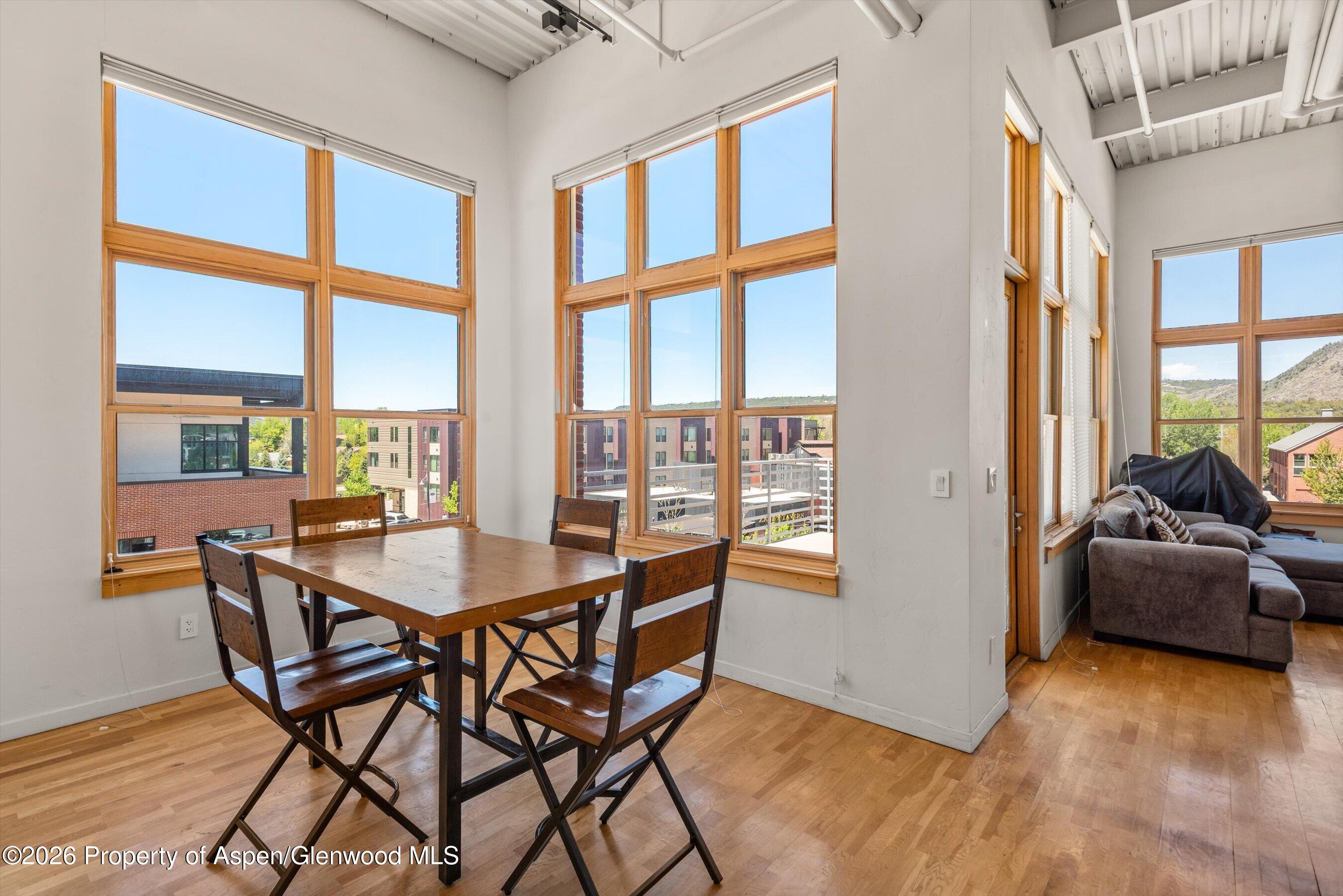231 Robinson Street, Unit 312 Basalt, CO 81621 - Photo 5 of 18 a dining room with furniture and large windows