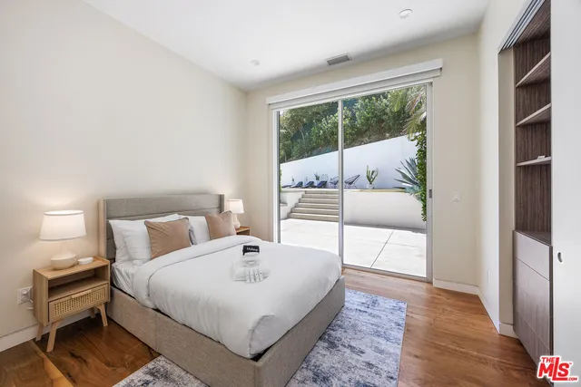 a bedroom with a bed and a large window