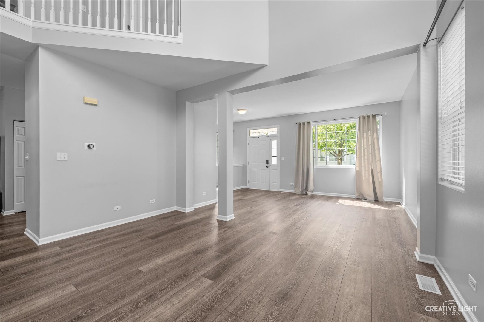 2296 Reflections Drive, Unit 2296 Aurora, IL 60502 - Photo 14 of 32 an empty room with wooden floor and windows