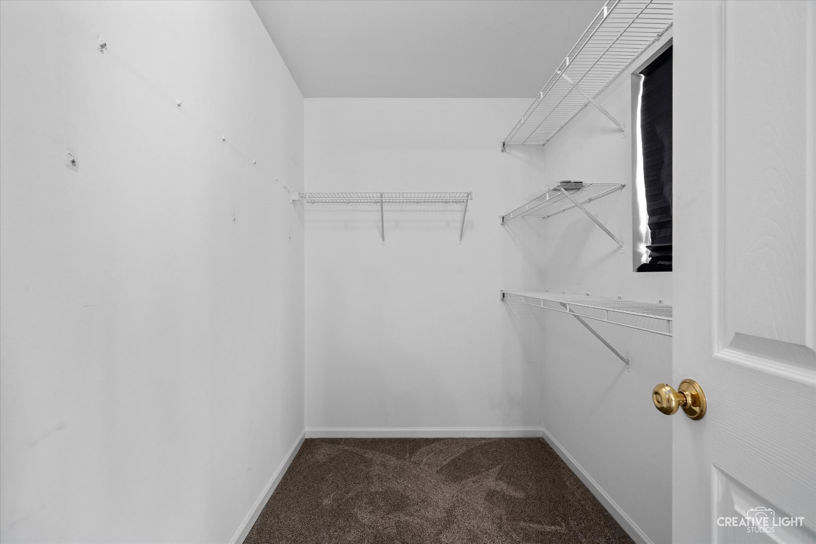 2296 Reflections Drive, Unit 2296 Aurora, IL 60502 - Photo 21 of 32 a view of a room with racks on the wall