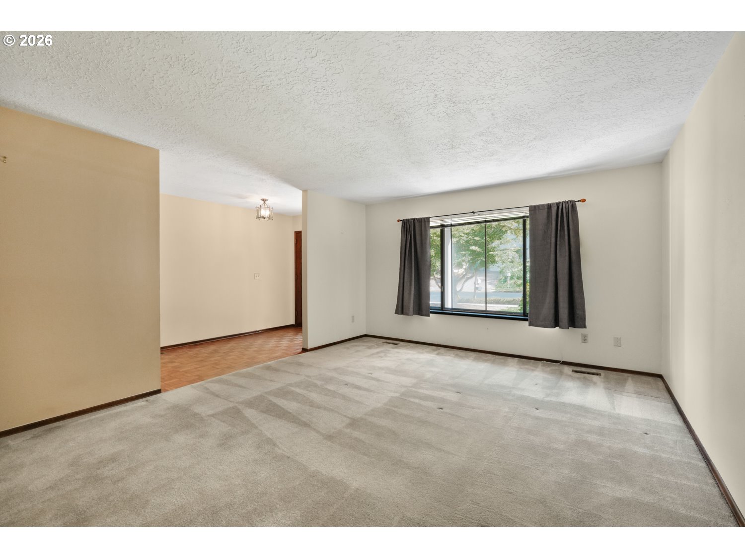 14155 Southwest 27th Street Beaverton, OR 97008 - Photo 6 of 27 a view of an empty room with windows