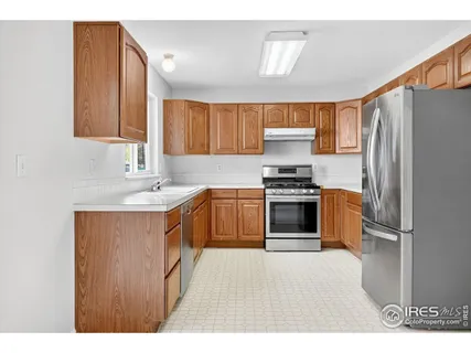 a kitchen with stainless steel appliances kitchen island a sink stove and cabinets
