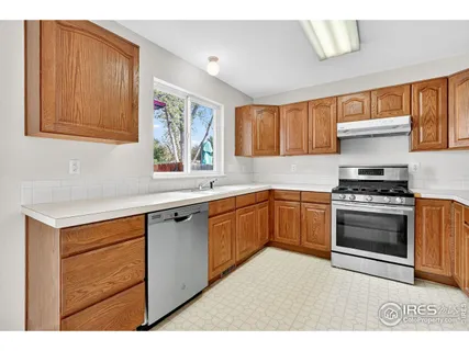 a kitchen with a refrigerator sink and cabinets