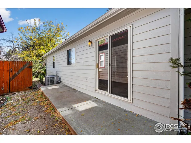 a backyard of a house with plants and tree