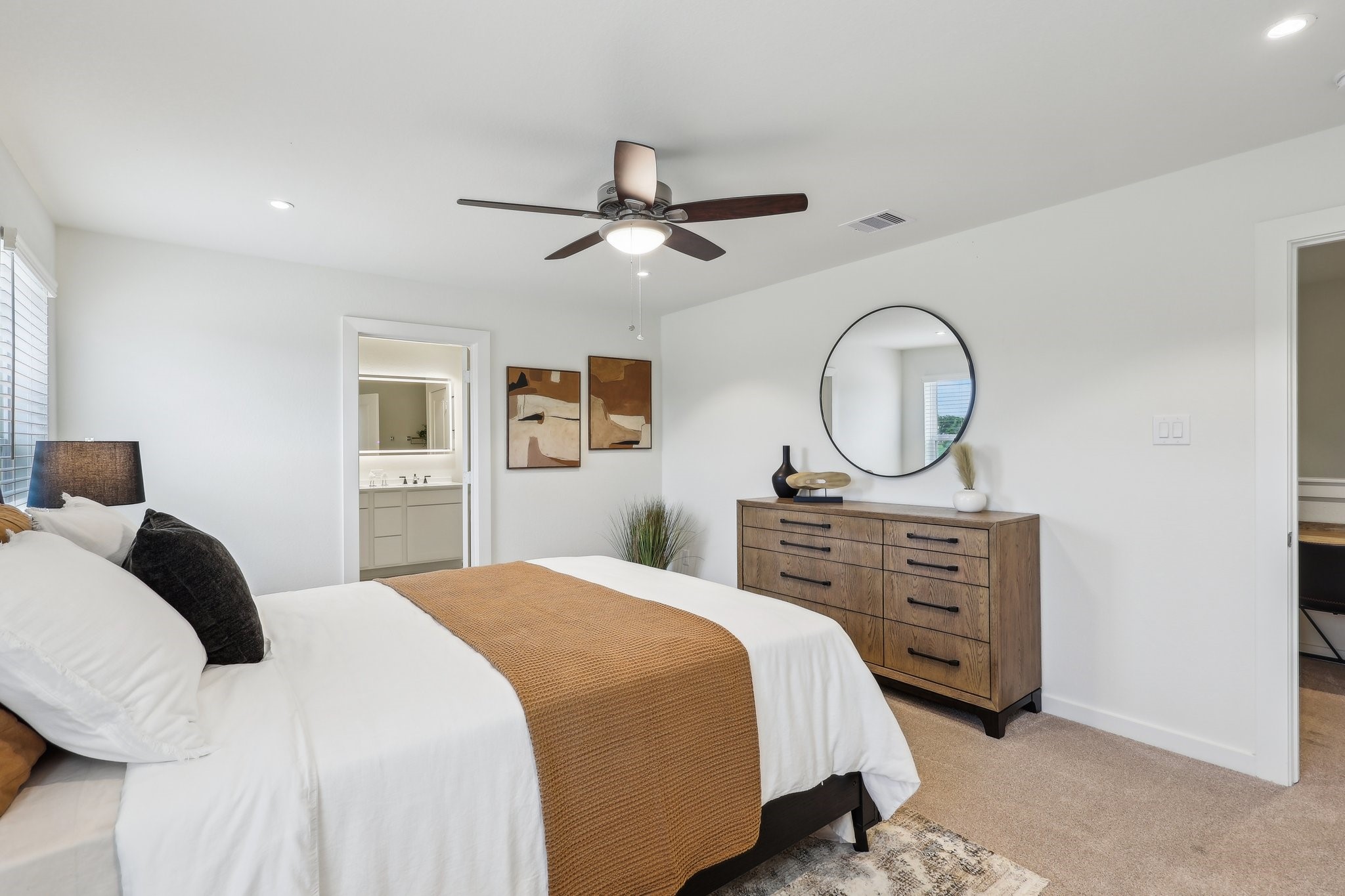 631 Canvas Avenue Fulshear, TX 77441 - Photo 12 of 30 a bedroom with a bed a dresser and a chandelier