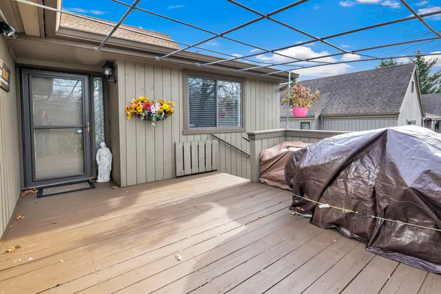 a view of a porch with furniture and wooden floor