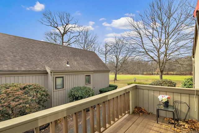 a view of a house with backyard and trees