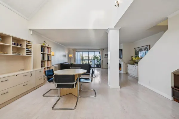 a work room with furniture a rug and a potted plant