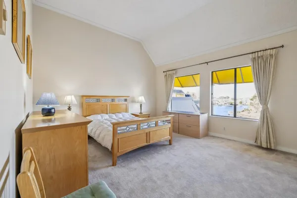 a bedroom with a bed and a large window