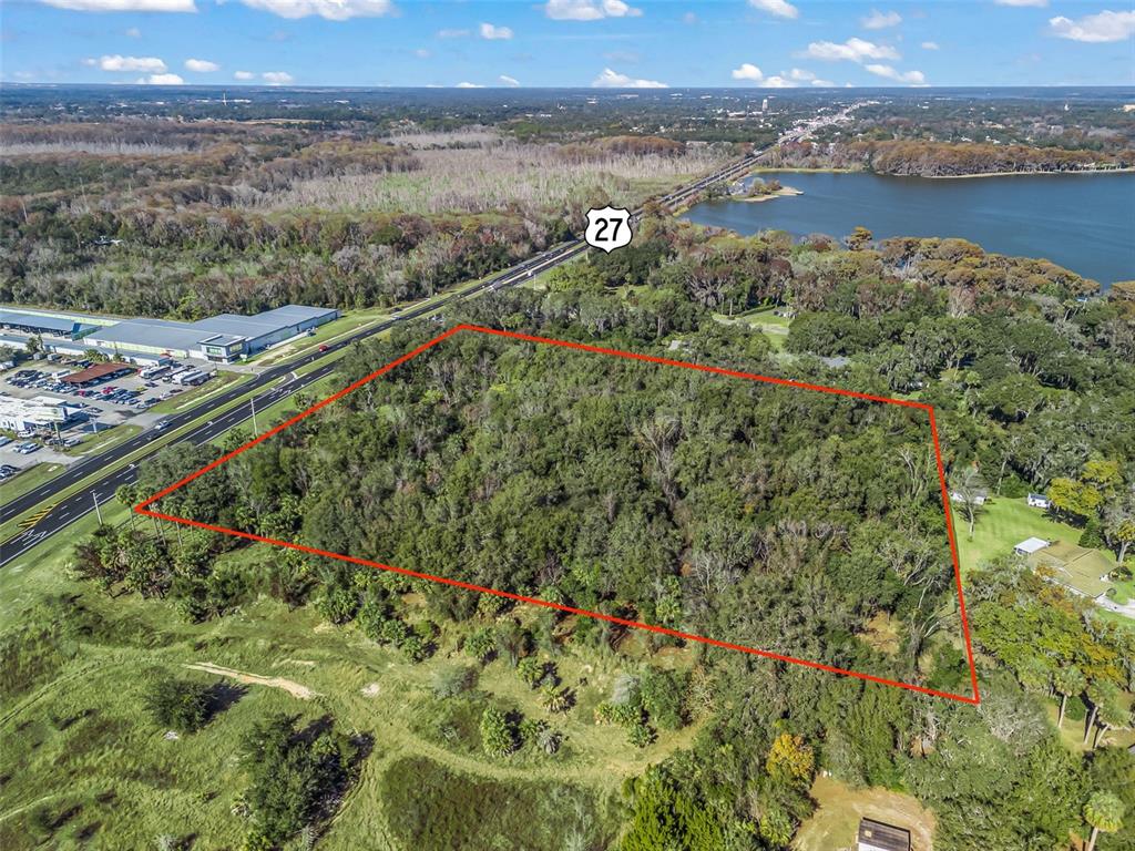 14th Street Leesburg, FL 34748 - Photo 18 of 26 a view of a lake with a mountain and a couple of trees