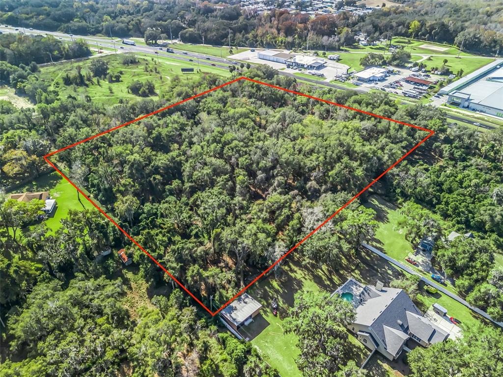 14th Street Leesburg, FL 34748 - Photo 22 of 26 an aerial view of residential houses with outdoor space and trees