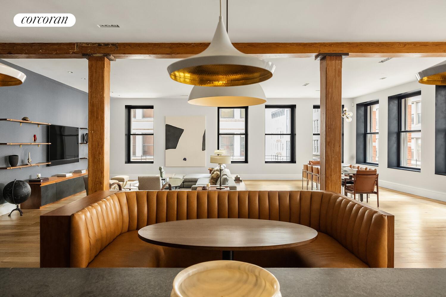 a living room with furniture a flat screen tv and a large window