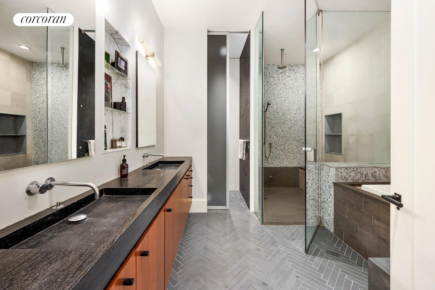 76 Crosby Street, Unit 4 Manhattan, NY 10012 - Photo 12 of 22 a bathroom with a granite countertop double vanity sink a mirror and a shower