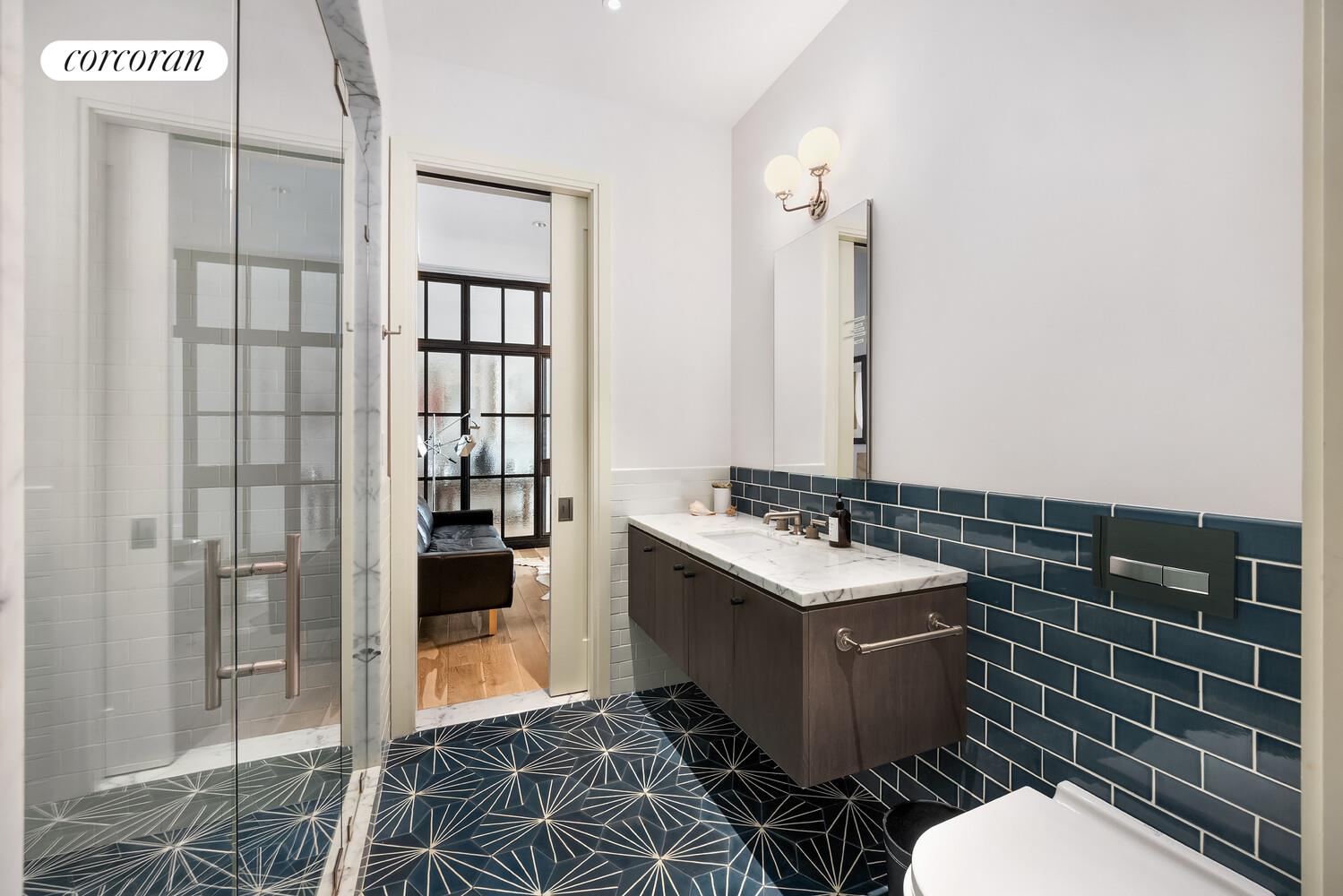 76 Crosby Street, Unit 4 Manhattan, NY 10012 - Photo 14 of 22 a bathroom with a sink toilet and shower