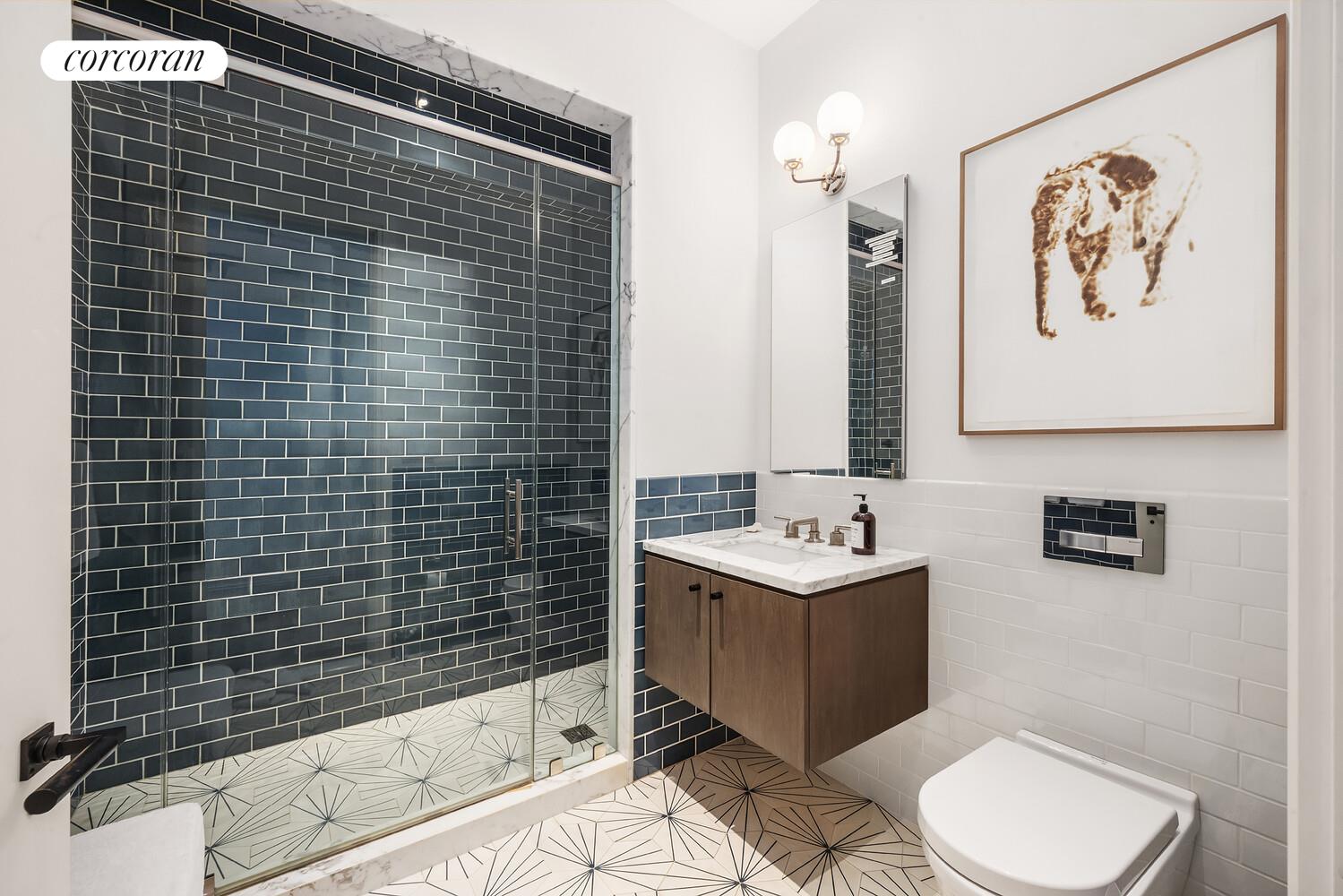 76 Crosby Street, Unit 4 Manhattan, NY 10012 - Photo 16 of 22 a bathroom with a sink toilet and shower