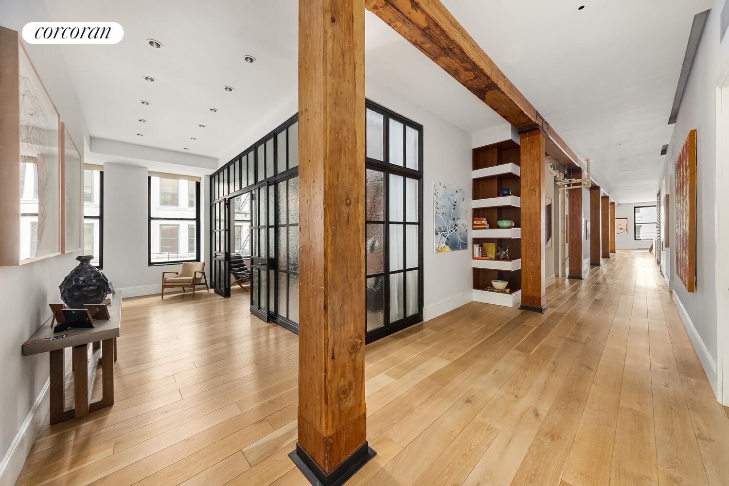 76 Crosby Street, Unit 4 Manhattan, NY 10012 - Photo 17 of 22 a view of a hallway with wooden floor and windows