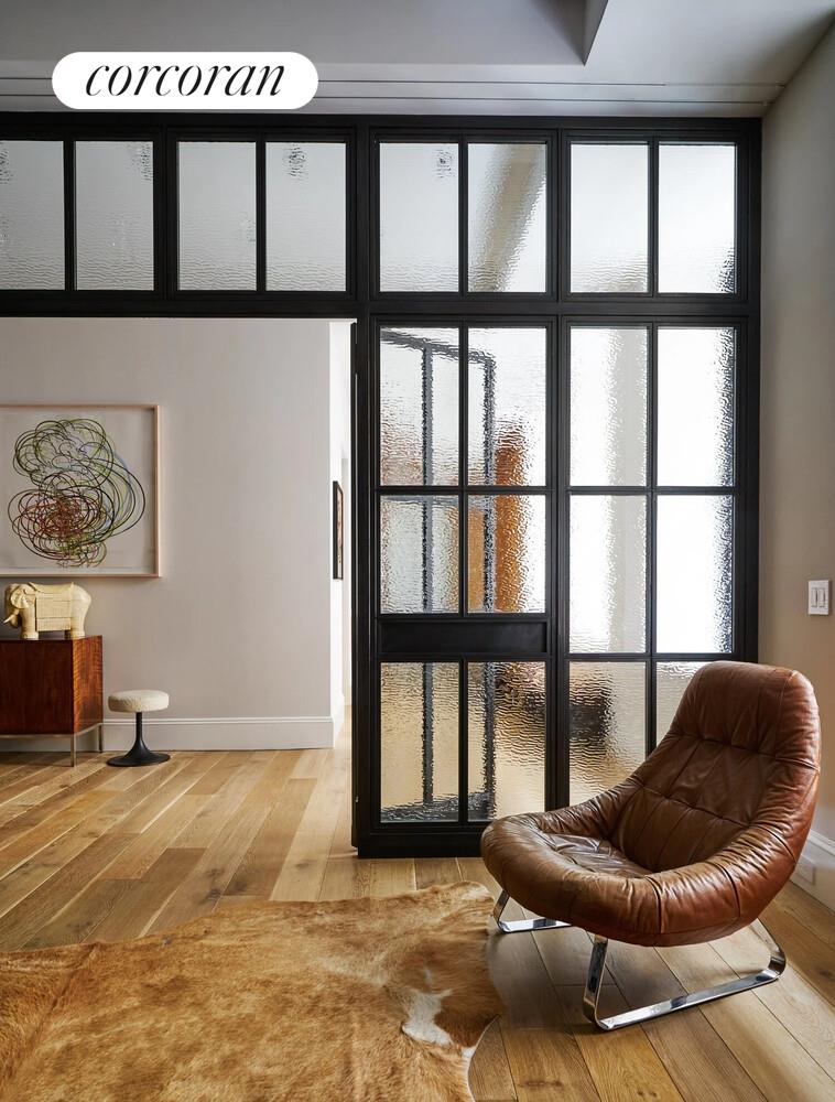 76 Crosby Street, Unit 4 Manhattan, NY 10012 - Photo 21 of 22 a living room with furniture and a large window