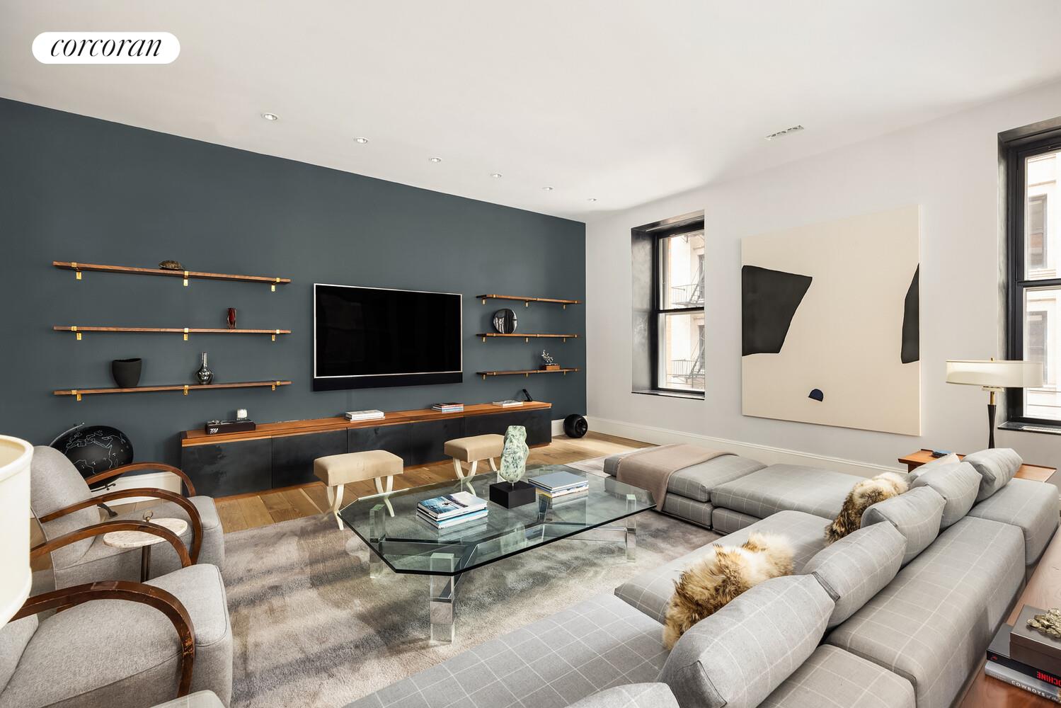 76 Crosby Street, Unit 4 Manhattan, NY 10012 - Photo 4 of 22 a living room with furniture and a flat screen tv