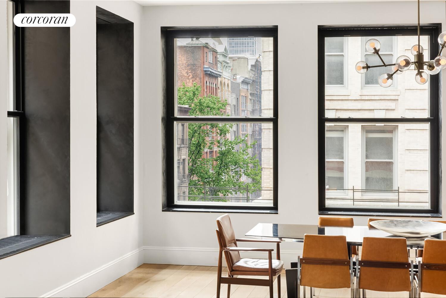 76 Crosby Street, Unit 4 Manhattan, NY 10012 - Photo 6 of 22 a balcony with table and chairs