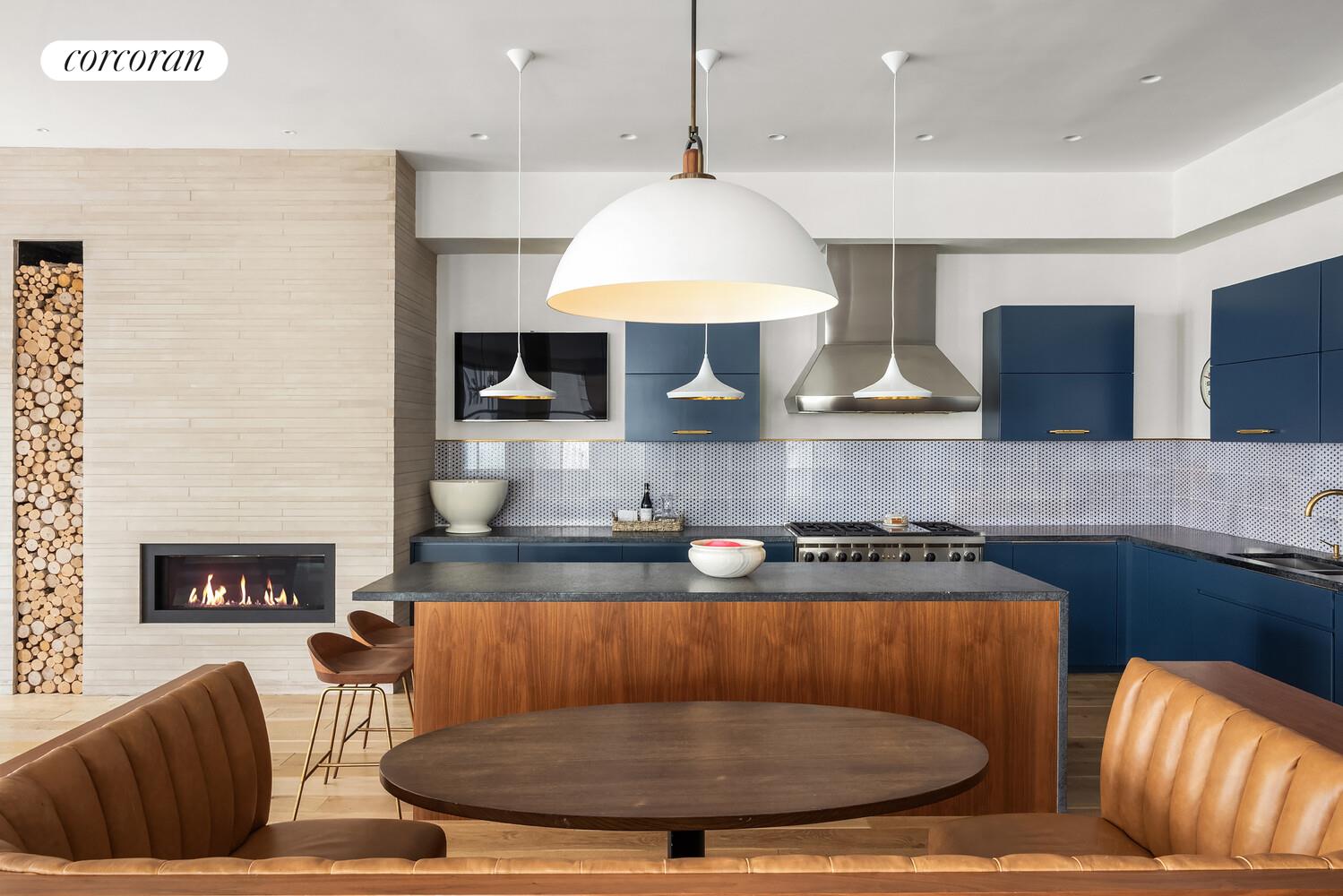 76 Crosby Street, Unit 4 Manhattan, NY 10012 - Photo 8 of 22 a kitchen with stainless steel appliances granite countertop a stove a sink a microwave a dining table and chairs