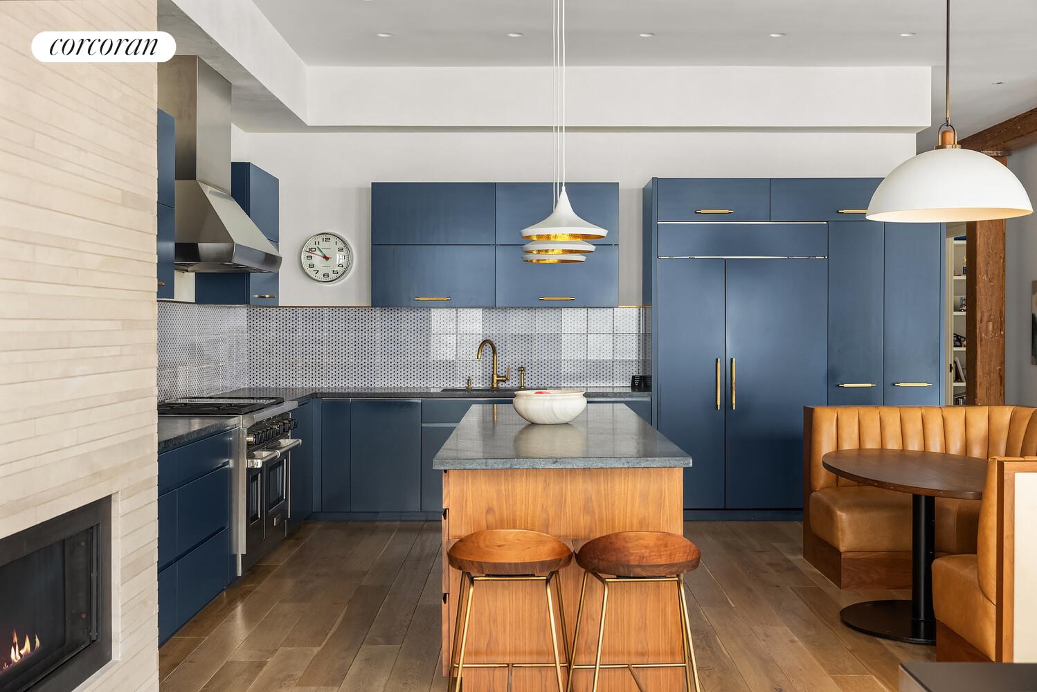 76 Crosby Street, Unit 4 Manhattan, NY 10012 - Photo 9 of 22 a kitchen with granite countertop a stove a sink and a refrigerator