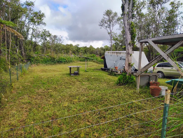 a backyard of a house with table and chairs