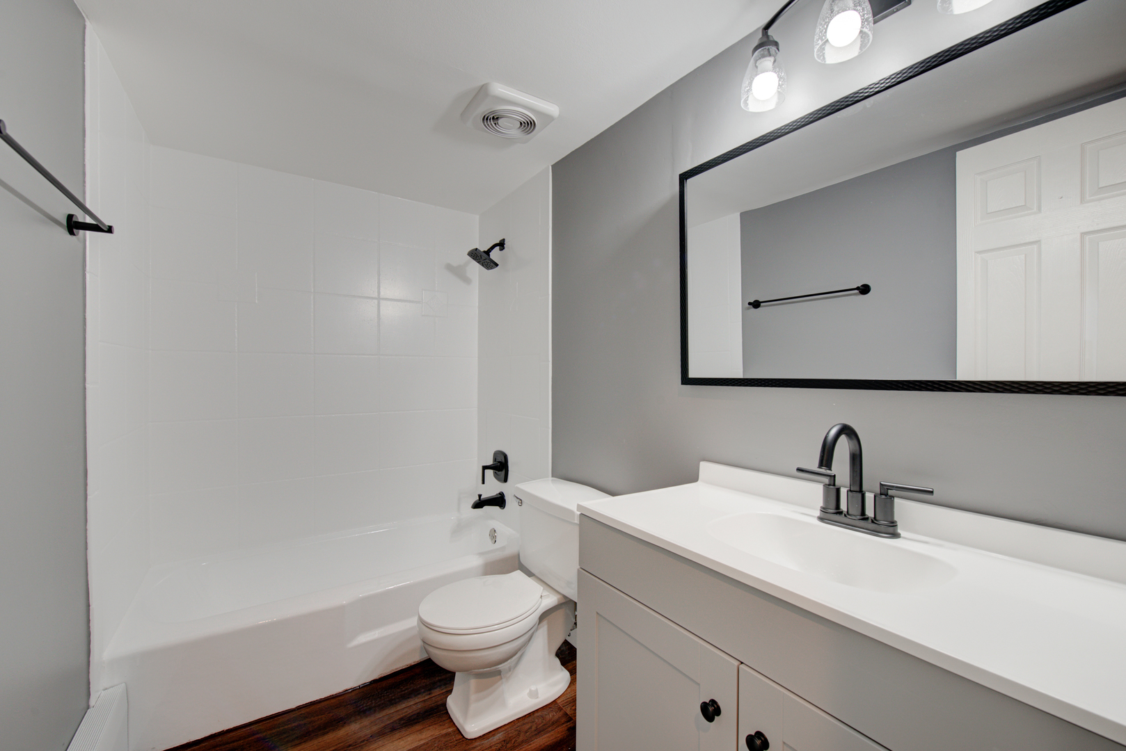 2323 South Goebbert Road, Unit 109 Arlington Heights, IL 60005 - Photo 14 of 22 a bathroom with a toilet a sink a mirror and vanity
