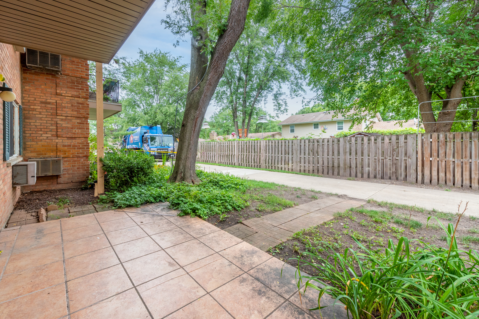 2323 South Goebbert Road, Unit 109 Arlington Heights, IL 60005 - Photo 15 of 22 a view of a backyard with a large tree