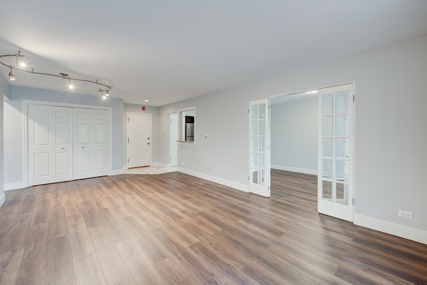 2323 South Goebbert Road, Unit 109 Arlington Heights, IL 60005 - Photo 6 of 22 an empty room with wooden floor
