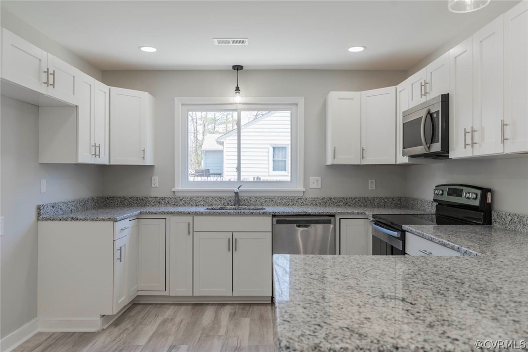 238 Monath Road North Chesterfield, VA 23236 - Photo 9 of 32 a kitchen with stainless steel appliances granite countertop a stove a sink and a microwave