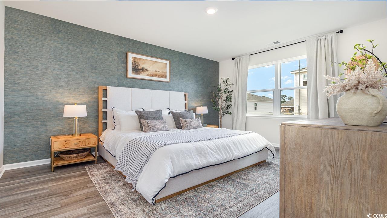 202 Dagger Court Myrtle Beach, SC 29588 - Photo 14 of 33 Bedroom featuring wallpapered walls, wood finished floors, an accent wall, and recessed lighting