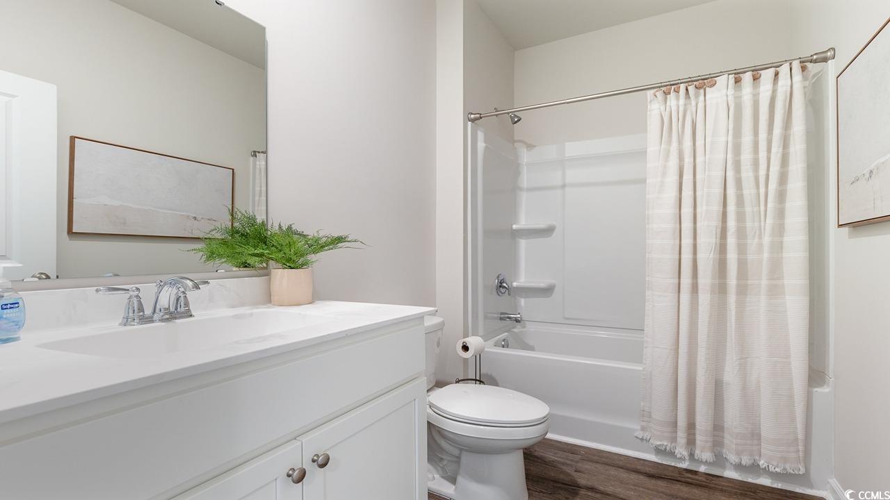 202 Dagger Court Myrtle Beach, SC 29588 - Photo 22 of 33 Bathroom with shower / bathtub combination with curtain, vanity, and dark wood-style flooring