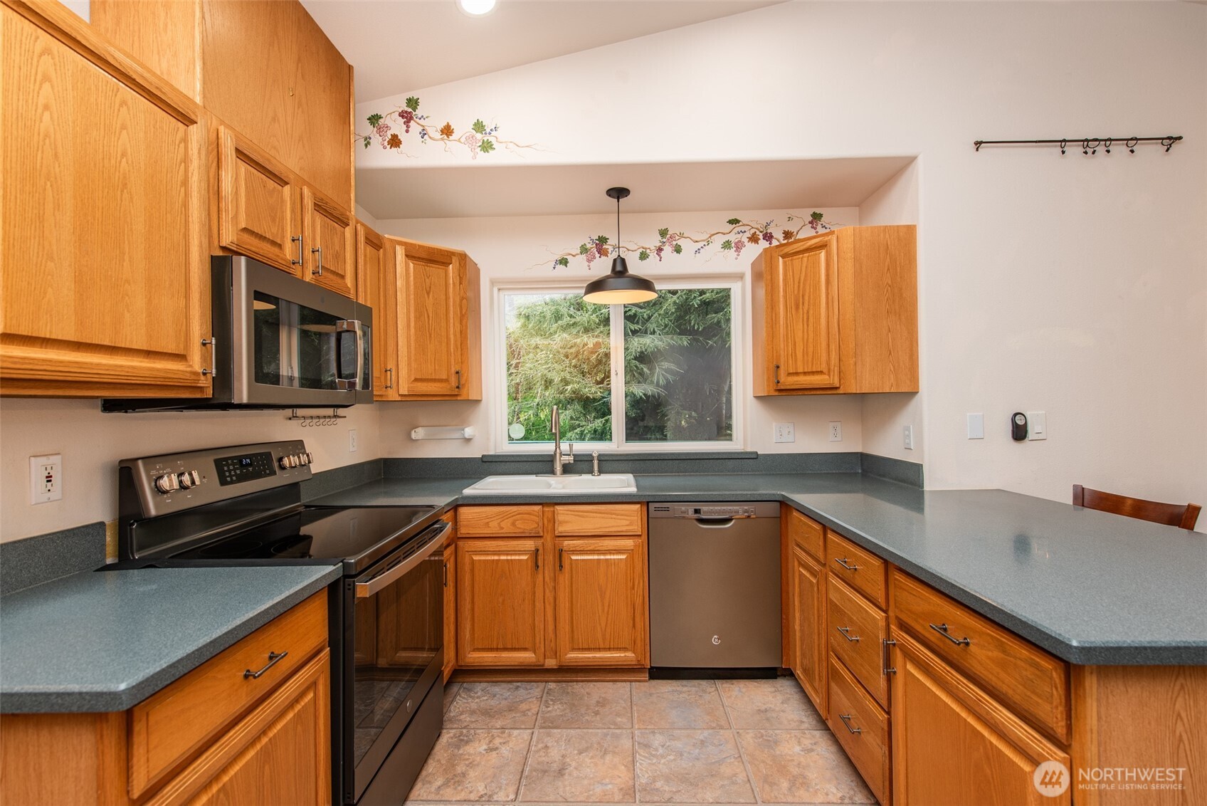 315 Dungeness Meadows Sequim, WA 98382 - Photo 12 of 36 a kitchen with stainless steel appliances granite countertop a sink stove and cabinets