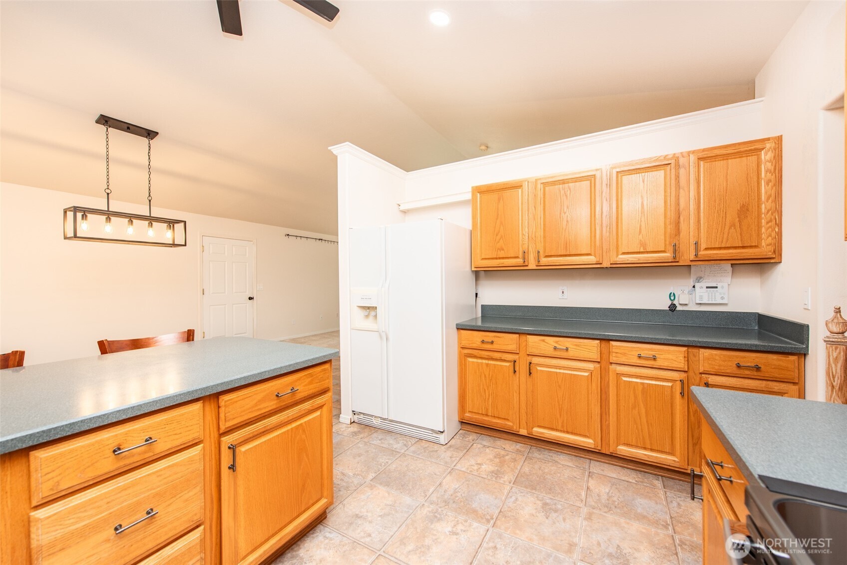 315 Dungeness Meadows Sequim, WA 98382 - Photo 13 of 36 a kitchen with stainless steel appliances granite countertop a sink and cabinets with wooden floor