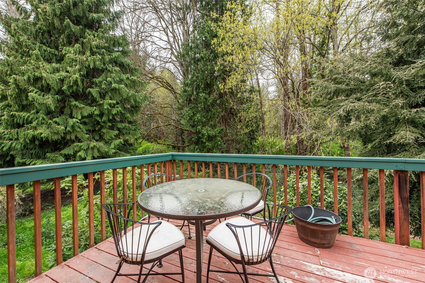 315 Dungeness Meadows Sequim, WA 98382 - Photo 26 of 36 a view of a balcony with wooden chairs and wooden floor