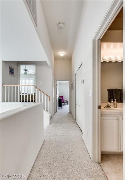 5272 Island Chain Road Las Vegas, NV 89118 - Photo 9 of 31 A well-lit hallway with plush carpeting and access to various rooms.