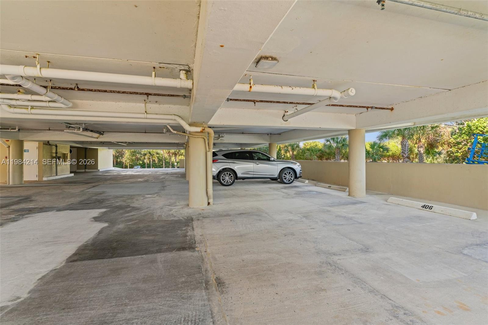 669 Northeast Plantation Road, Unit 406 Stuart, FL 34996 - Photo 26 of 41 a view of parking area and car parked