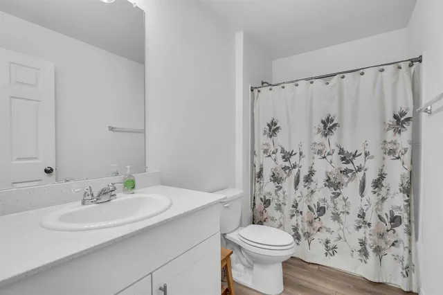 a bedroom with furniture and a ceiling fan