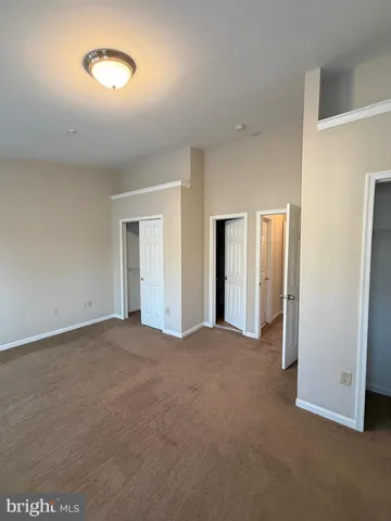 a view of an empty room with a closet
