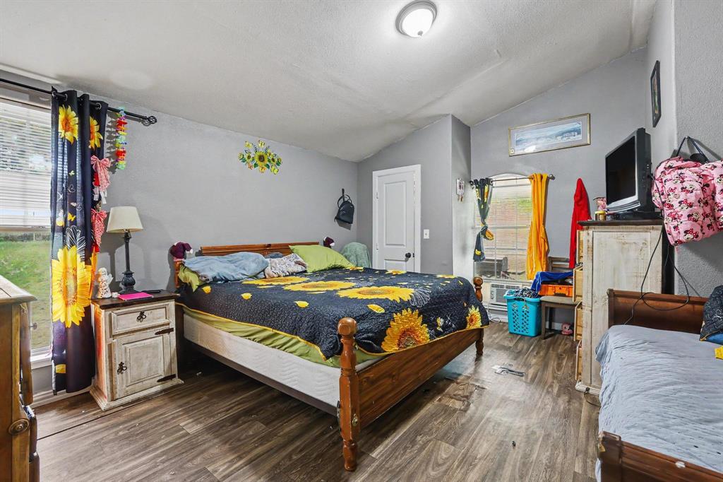 205 South Main Street Bonham, TX 75418 - Photo 15 of 23 a bedroom with a bed and a dresser