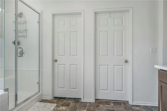 a view of walk in closet with clothes