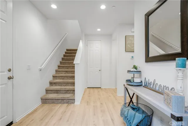 a view of entryway and hall with wooden floor