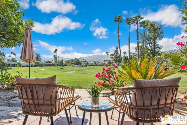 a view of a chairs and table in backyard