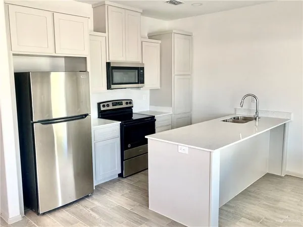 a kitchen with a sink stainless steel appliances and cabinets