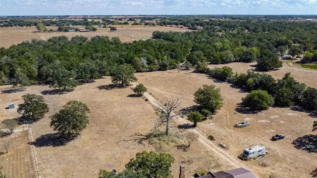 an aerial view of a house with yard and ocean view