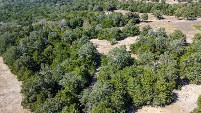 an aerial view of a houses with a yard